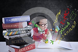 Boy studying with books and formula