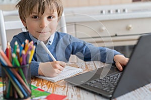 Boy studying home online while school is closed