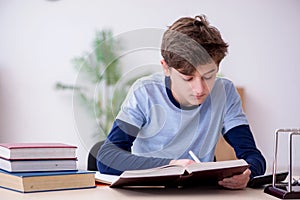 Schoolboy studying physics at home