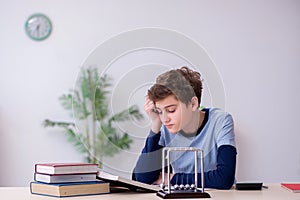 Schoolboy studying physics at home