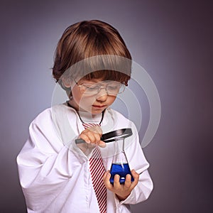 Boy studying a substance in a test tube