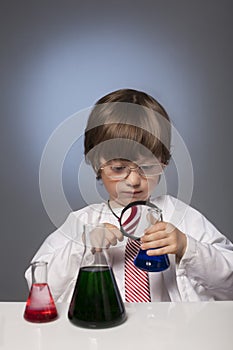 Boy studying a substance in a test tube