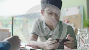 Boy Studying Using Digital Tablet At Home with friend.