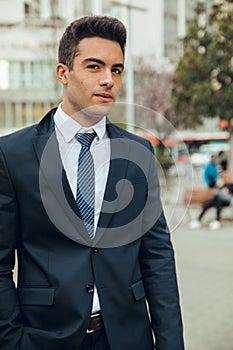 Boy in suit smoking with vaper