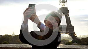 Boy in a suit taking selfie photo with smartphone