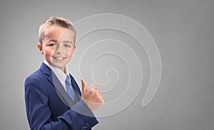 Boy in suit with thumbs up agreeing and giving his approval