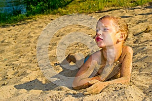 Boy sunbathes on the sand