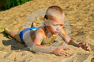 Boy sunbathes on the sand