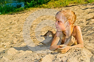 Boy sunbathes on the sand