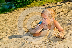 Boy sunbathes on the sand