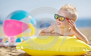 Boy sunbathing on an inflatable mattress