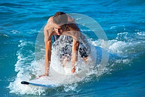 Boy surfer surfing waves on the beach