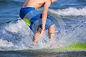 Boy surfer surfing waves on the beach