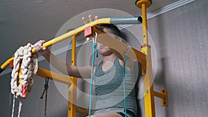 Boy on Swedish Wall Preparing for Pull-ups on Horizontal Bar. Warming up Body