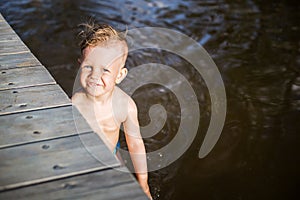 Boy swim near footbridge