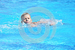 Little boy and watersports. Active holiday in the pool. swim practice