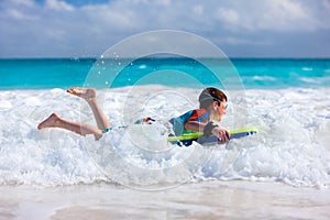 Boy swimming on boogie board