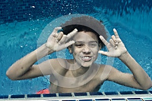 Boy Swimming In Glass Pool 