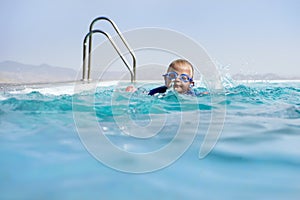 Boy Swimming In an Infinity Pool