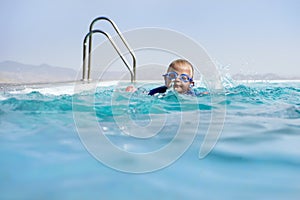 Boy Swimming In an Infinity Pool photo
