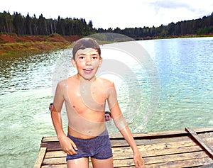 boy swimming in the lake on their summer country holiday