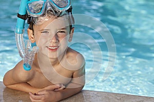 Boy In Swimming Pool With Blue Goggles & Snorkel