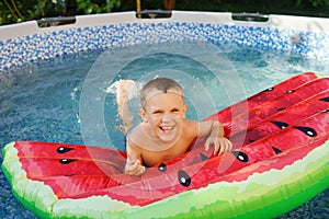 Boy swimming in the pool. Summer background. Happy moments. Have fun. Active life.