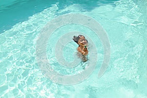 Boy In Swimming Pool. Summer Entertainment For Fun In Turquoise Water At Resort.