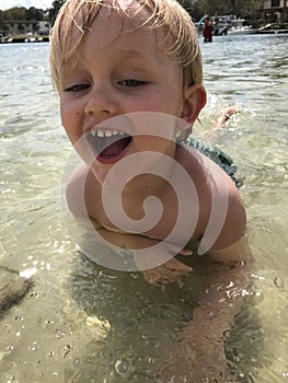 Boy Swimming in Shallow Water