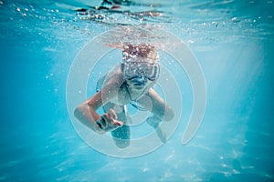 Boy swimming under water