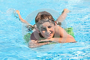 Boy swims in a pool during vacation