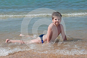 A boy swims in the sea