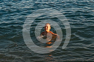 Boy swims on the sea