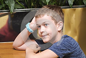 Boy at a table in a cafe