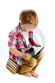 Boy with a Tablet PC sitting on the books