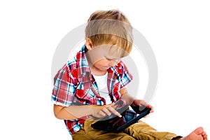 Boy with a Tablet PC sitting on the floor