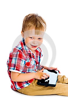 Boy with a Tablet PC sitting on the floor