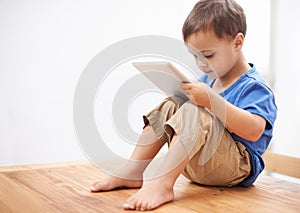 Boy, tablet and typing with games, home and internet with network, connection and digital app for learning. Child