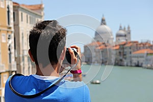 boy takes pictures at Basilica called Madonna della Salute in Ve