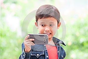 Boy takes selfie with mobile phone