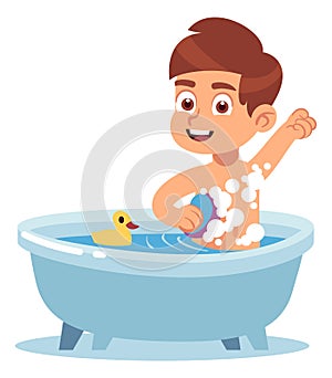 Boy taking bath in bathtub with rubber duck. Kid hygiene