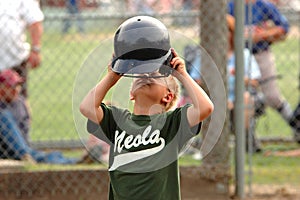 Boy Taking Off Batting Helmet