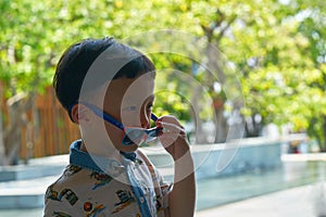 Boy is taking off sunglasses while in travelling trip