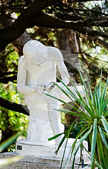 Boy taking out a splinter. Sculpture.