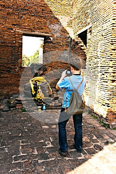 Boy taking picture inside