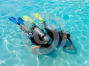 A boy taking scuba diving lessons.