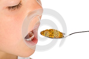 Boy taking a spoonful of pollen