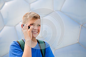 Boy talking on cell phone in the Olympic Park, Beijing