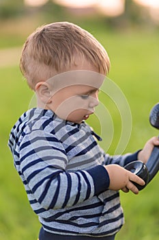 Boy talking on an old phone while standing in the middle of the street