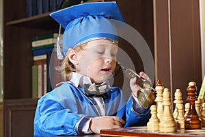 Boy talking on the phone while playing chess